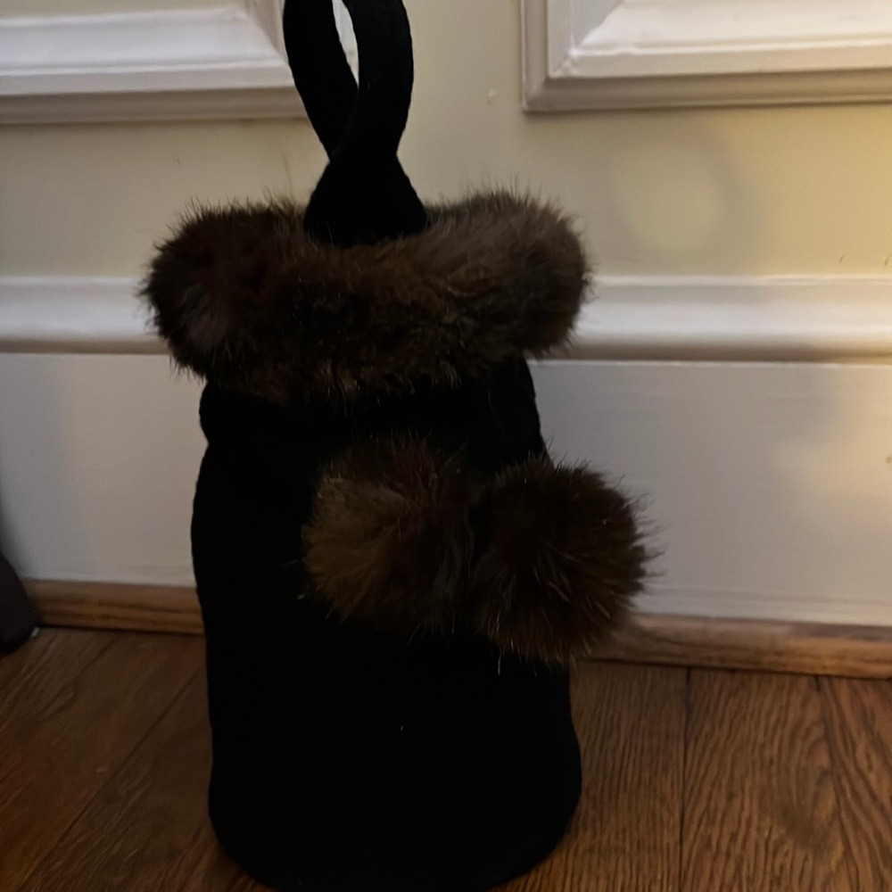 Unique felt bag with faux fur trim and Pom Pom draw string closure.